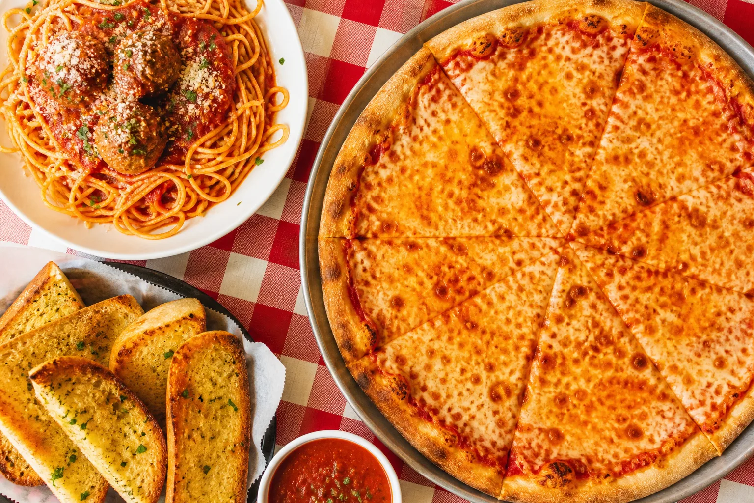 Pizza, spaghetti and meatballs, and garlic bread at Luigi's in Pacifica